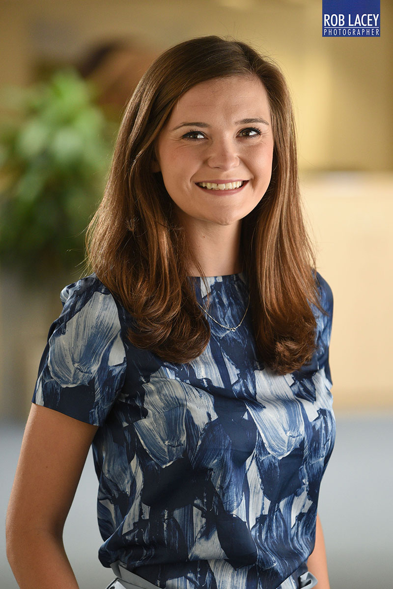 Headshot female office background blue dress 3/4 length